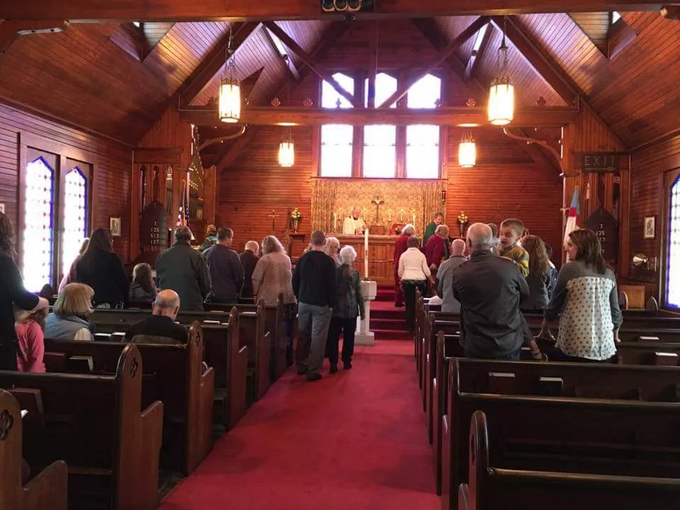 The warm wood interior of St. John's Episcopal Church during worship
