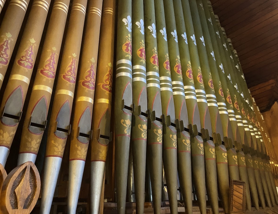 Painted and gilded organ pipes rising in the choir loft of St. John's Episcopal Church